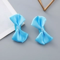 Pair of bright blue polyester satin bow hair clips with a smooth silk texture finish - Blue