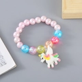 Pink pearl beads children bracelet with sparkly white unicorn pendant and colorful accents - Pink