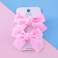 Pair of handmade pink ribbon bow hair clips for girls on a white display card - Pink