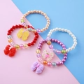 Kids colorful pearl bead bracelet set with bow pendants in red, white, and purple - Random (Sampling)