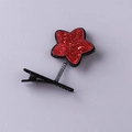 Cute kids hair clip featuring a red sequined star on a flexible black spring base - Sequin Flower Red