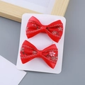 Pair of red satin bow hair clips with cherry blossom embroidery on a display card - Vintage Style Bow