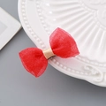 Red mesh bow hair clip with a pink satin center on a white ceramic plate - Red Bubble Gauze Hair Clip