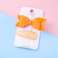 Sparkly orange sequin bow hair clips set for girls on a white handmade display card - Orange