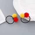 New Year hair ties with red and yellow plush balls and elastic black rubber bands - Pom Pom Hair Tie