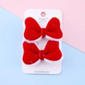 Pair of handmade red velvet bow hair clips with white plush trim for festive occasions - Red Velvet Glitter Style