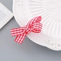 Festive red and white striped bow hair clip for New Year on a decorative white plate - Four-Corner Bow Hair Clip