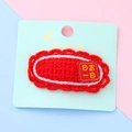 Red knit hairpin for kids with embroidered blessing text on a soft pastel background - Daily Wealth (3#)