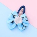 Cute light blue ribbon flower hair clip with purple resin sunflower and black script detail - Sun