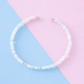 Minimalist white beaded bracelet with iridescent accents on pink and blue background - Iridescent White (1#)