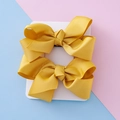 Pair of yellow grosgrain ribbon hair bows for girls on a white display card - Gold Yellow