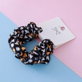 Halloween black scrunchie with white ghost and orange pumpkin prints on festive background - Black Pumpkin Style