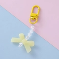 Detail of yellow acrylic bow keychain with transparent beads and spring clip - Yellow Style 2