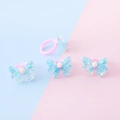 Anello per bambini in resina rosa con fiocco blu glitterato in un set da quattro - Stile Fiocco Blu