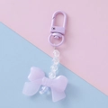 Detailed view of a purple acrylic bow keychain with clear faceted beads and charms - Purple 1#