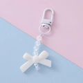 Close-up of white resin bow keychain with iridescent beads and transparent faceted crystals - White 2#