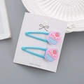 Lot de deux barrettes bleu ciel pour filles avec d'adorables motifs de cupcakes - Glace Bleue