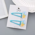 Joli lot de deux barrettes à cheveux glace bleu clair pour filles sur carte blanche - Cône de Glace Bleu