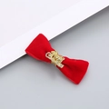 Close-up of red velvet Christmas headband bow with golden Merry Christmas engraving - Velvet Small Bow Hair Clip