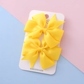 Pair of bright yellow grosgrain ribbon bow hair clips on a handmade display card - Yellow