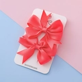 Paire de barrettes à nœuds en gros-grain rose corail sur carte fait main - Rouge clair