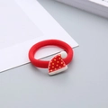 Detail of red elastic hair tie with a festive Christmas hat and star decoration - Christmas Hat Hair Tie