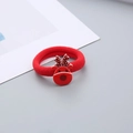 Primer plano de un coletero rojo con dije de reno para peinados navideños - Coletero de Reno