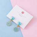 Kids clip-on earrings featuring blue enamel snowflake and heart charms on a display card - Blue Plumbago