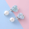 Kids' blue glitter heart clip-on earrings with large white pearls on a pastel background - Blue Heart Clip On Earrings