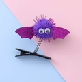 Cute Halloween hair clip featuring a purple glitter bat with spring and plush ball - Purple Pompom Bat Style