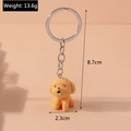 Detalle de llavero de perro teddy naranja con rizos, anilla plateada y dimensiones - Perro Teddy