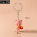 Detail view of pink pig keychain showing 10.2cm height and 20.5g weight dimensions - Fries Pig