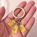 Fashionable keychain with three translucent yellow resin bears featuring aurora sequins - Transparent Yellow
