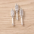 Macro detail of three silver alloy screwdriver charms for DIY jewelry making - Screwdriver