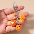 Detail of cute orange bear and pig resin pendants on a silver metal keychain - Orange Animal Cartoon Pendant / Elephant Panda Head