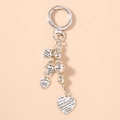 Detail of silver heart pendants with engraved messages on a metal keychain - Letter Heart