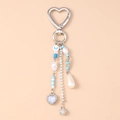 Detail of heart keychain with blue beads, sparkling rhinestone chain, and drop pearl - Blue