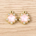 Detailed macro view of two gold pentagram pendants with pink crystals and rhinestones - 5 Pieces / Gold Pink