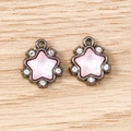 Macro shot of two gunmetal star pendants with pink rhinestones on a light wooden background - 5 Pieces / Dusty Pink