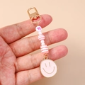 Fashion beaded smiley face keychain with pink letter F and golden spring clasp charm - Pink