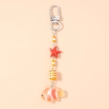 Close-up of a starfish and clownfish keychain pendant with orange beads and silver clasp - Orange Goldfish
