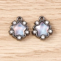 Macro shot of gun-black star charms with moonstone-effect glass and tiny rhinestones - 5 Pieces / Grey Purple