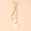 Détail d'un porte-clés chien mignon avec enveloppe cœur, perles et fermoir en cœur - Chien Cœur Œil Rose