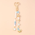 Detail of beaded keychain with heart clasp, pearls and blue moon wave pendant charms - Heart Moon Beaded