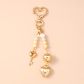 Golden heart-shaped keychain with elegant white pearls and a star-shaped crystal charm - Gold Heart Key