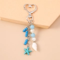Ocean-themed keychain with heart clasp, blue starfish, white shells, and colorful beads - Blue Conch Starfish