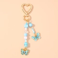 Dettaglio portachiavi farfalla con strass blu, perline e chiusura a cuore dorata - Farfalla Blu