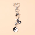 Detail of Yin Yang keychain featuring heart clasp, enamel pendants, and decorative pearls - Bagua Tai Chi