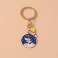 Detailed macro view of enamel round keychain with pink fairy and blue starry night sky - Cloud Fairy