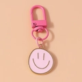 Detail eines rosa Emaille-Smiley-Anhängers mit passendem Karabinerverschluss - Rosa